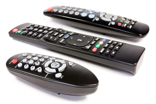 three remote controls over a white background