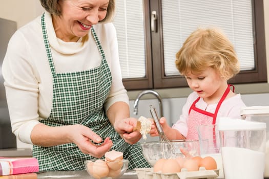 Grandmother and granddaughter baking cookies prepare dough