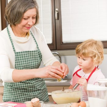 Grandmother and granddaughter baking cookies prepare dough