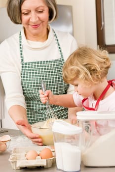 Grandmother and granddaughter baking cookies prepare dough