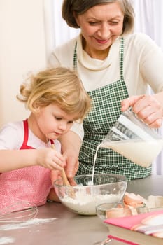 Grandmother and granddaughter baking cookies prepare dough