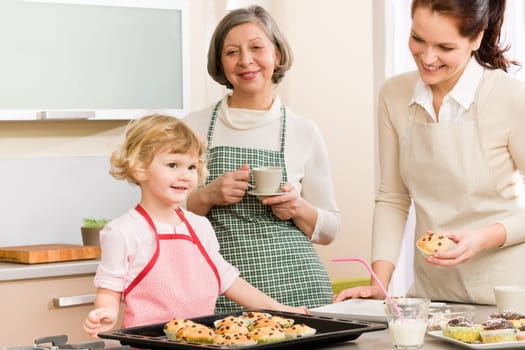 Grandmother, mother and child girl making cupcakes in kitchen