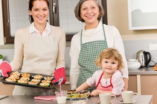 Family women baking cupcakes in kitchen grandmother, mother and granddaughter