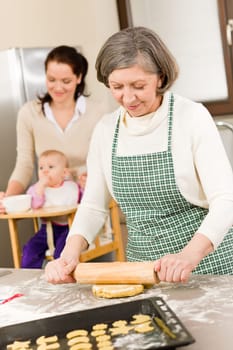 Senior woman rolling dough prepare for baking cookies in kitchen