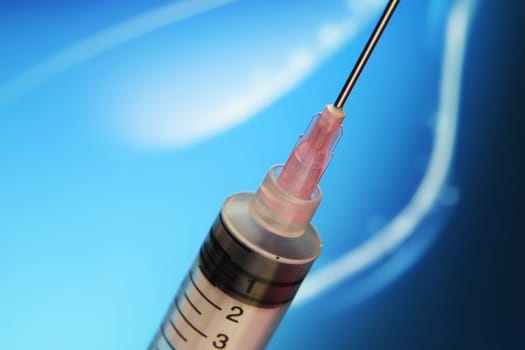 Syringe against blue background