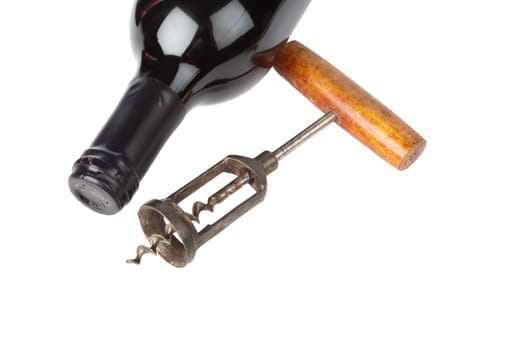 Corkscrew and wine bottle against white background