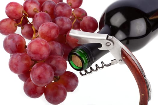 Wine bottle with corkscrew and grapes