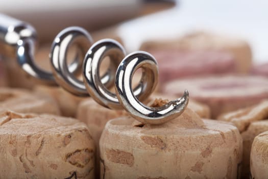 Close-up of a corkscrew spiral in front of cork