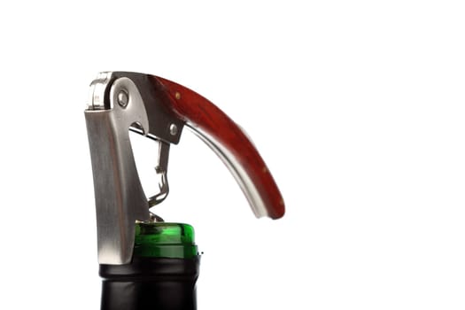 Noble corkscrew on wine bottle against white background