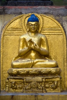 Golden statue of Buddha sitting in calm composition at Mahabodi Temple, Bodhgaya, Bihar, India, Asia