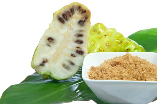 two noni fruit on white background