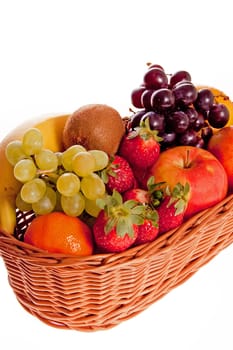 Various fresh ripe fruits placed in a wicker basket