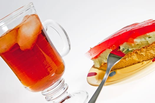 Iced tea and cake dessert with a red jelly
