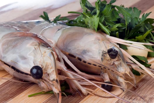 Giant shrimp on a wooden cutting board bamboo