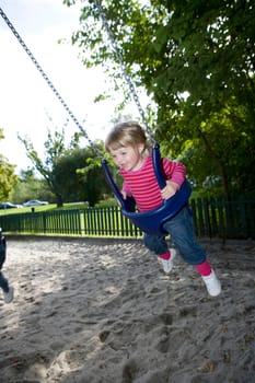 Young Happy Girl in the Swing