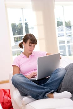 Woman with computer in the sofa