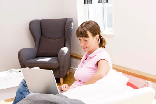 Woman with computer in the sofa