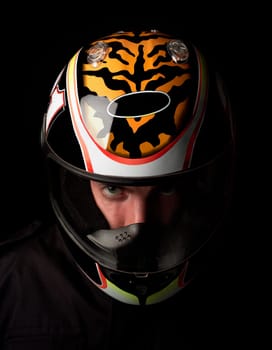 Man with motorcycle helmet on black background