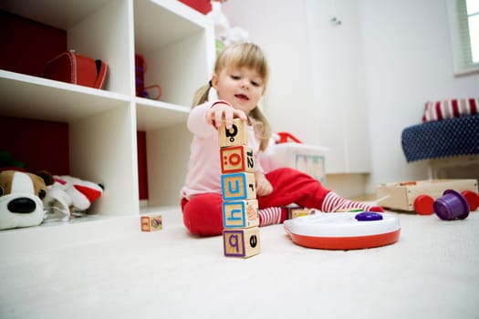 Baby girl playing in her room