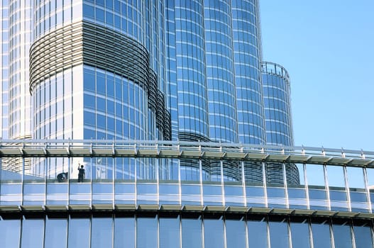 Two workers washing windows of the modern building.