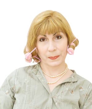 Blonde housewife wearing hair rollers and getting ready to go party. Real woman. Isolated over white background.
