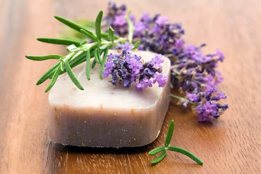 bar of natural soap and lavender flowers