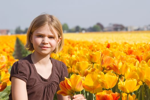 little girl in tulips field