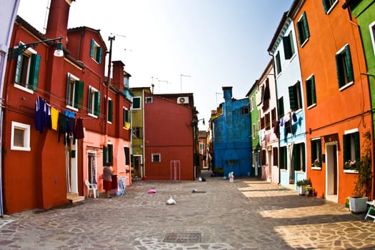 colorful facade of an old fisher house and street in the village of Burano near Venice