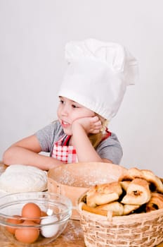 Chef Girl sitting at the table and thinks