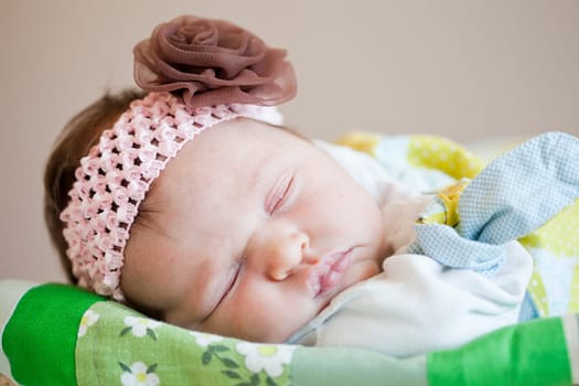 Portrait of a cute newborn baby girl sleeping in a basket