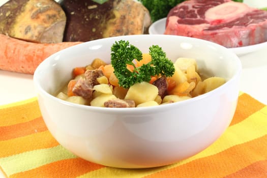 a bowl of rutabaga stew with parsley and boiled meat