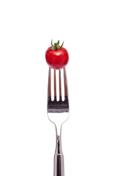 A red cocktail tomato on a fork
