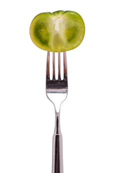 A green tomato is skewered on a gable
