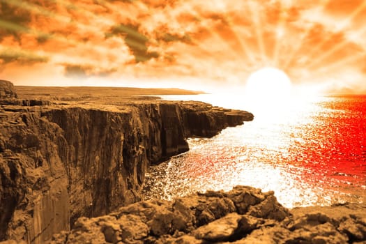 golden sunset from the cliffs edge on a rocky landscape of the burren in county clare ireland