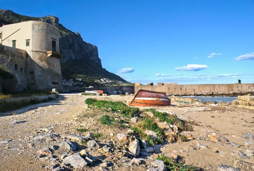 landscape of Palermo, Arenella- Sicily. old boats and fisherman in the distance