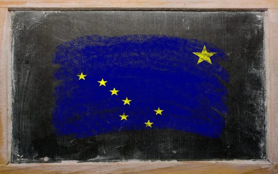 Chalky american state of alaska flag painted with color chalk on old blackboard