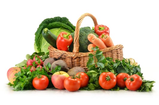 Composition with raw vegetables and wicker basket isolated on white