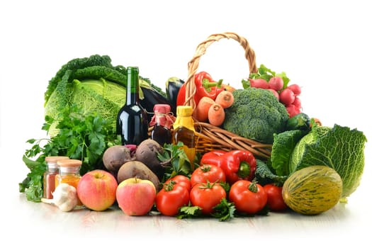 Composition with raw vegetables and wicker basket isolated on white