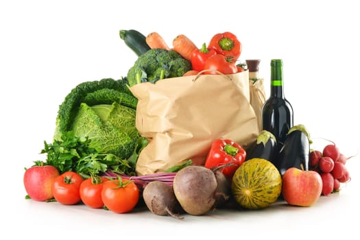 Composition with raw vegetables and shopping bag isolated on white