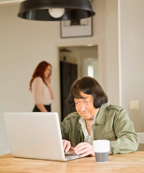 Senior woman by the computer