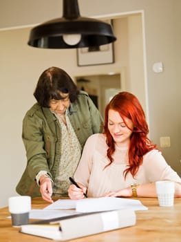 Grandmother helping her grandaughter with paperwork