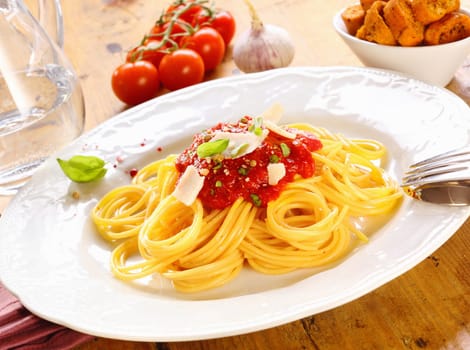 Plate of freshly prepared spaghetti bolognaise with a tomato sauce and cheese ready to be served.