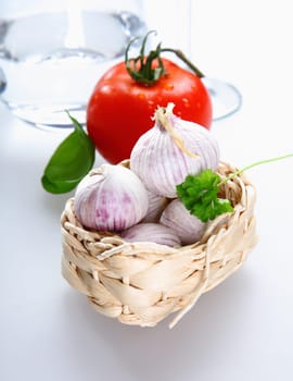 A basket with Tomato and garlic and parsley on white background for italian concepts