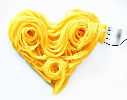Cooked plain spaghetti coiled and looped into a heart shape symbolic of Valentine, romance and love.