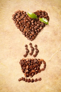 Hot Coffe Cup and a heart shape figured with coffee beans
