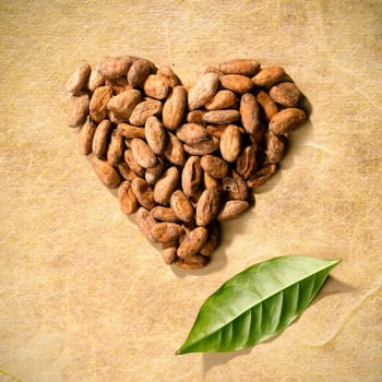 Heart of Coffee with a green leaf on a grunge background