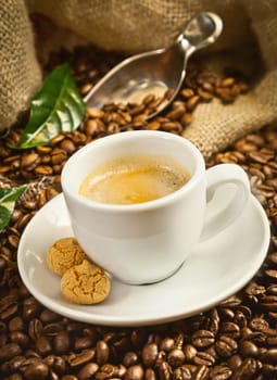 Espresso cup with fresh brewed coffee and beans