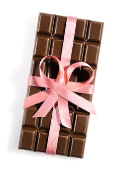 Chocolate bar with a rose or pink ribbon or bow isolated on white background