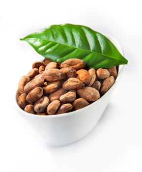 A bowl of cocoa with a green leaf isolated on white