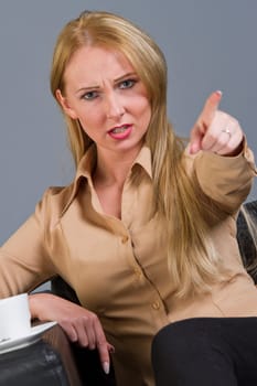 frustrated woman pointing with a finger in the camera
